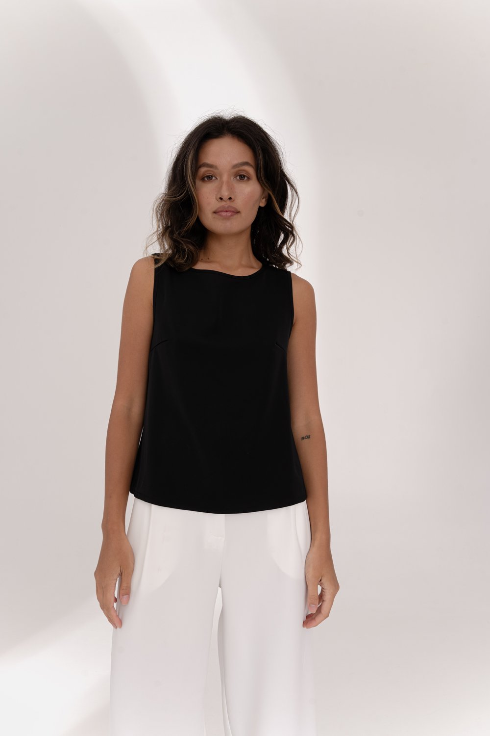 Black sleeveless top with lace insert on the back
