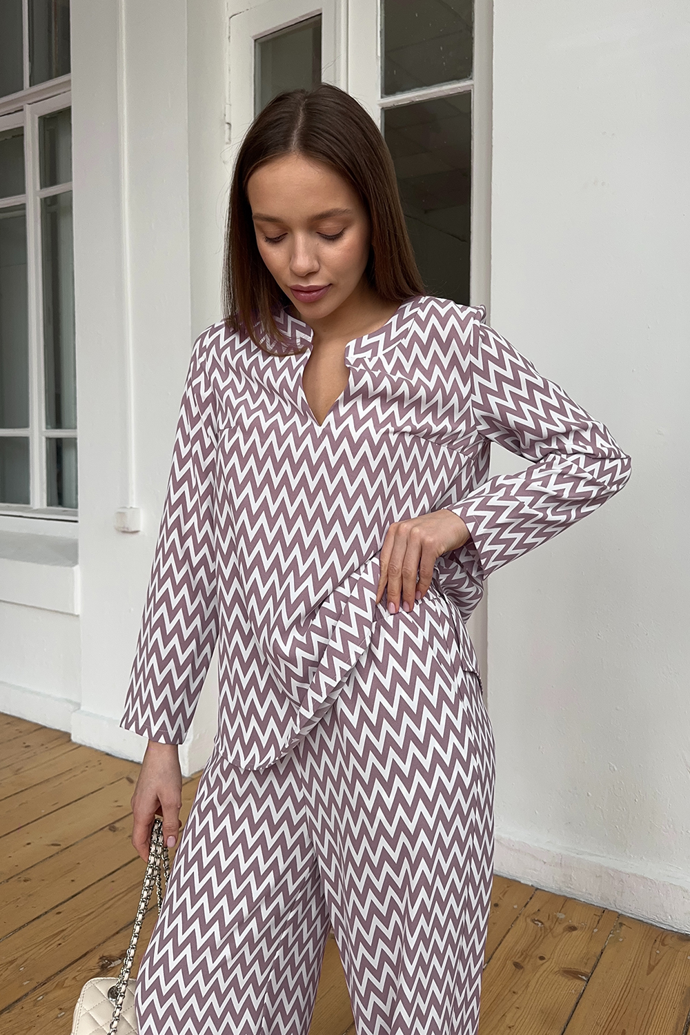 Pink trouser suit with slits and a shaped neckline