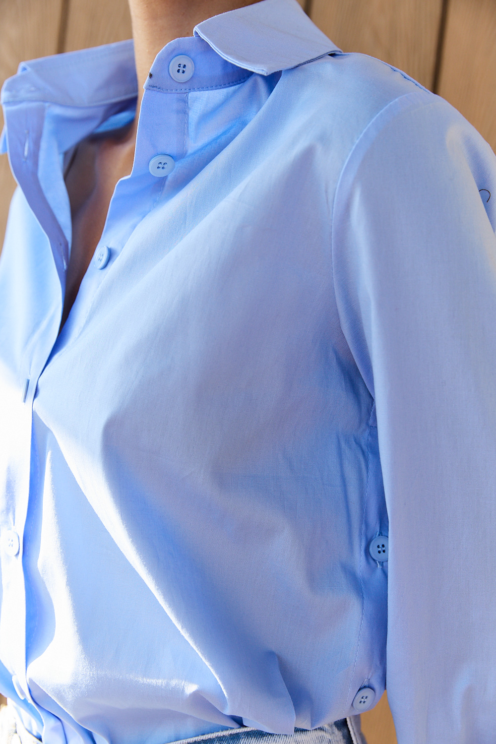 Blue cotton shirt with functional buttons on the sides