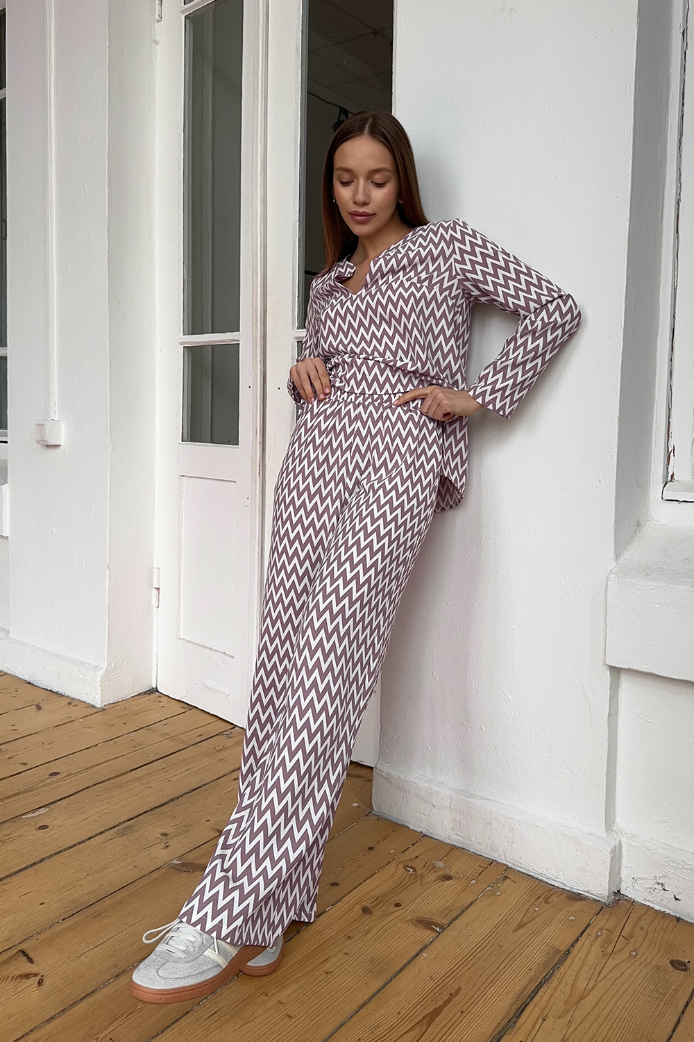 Pink trouser suit with slits and a shaped neckline