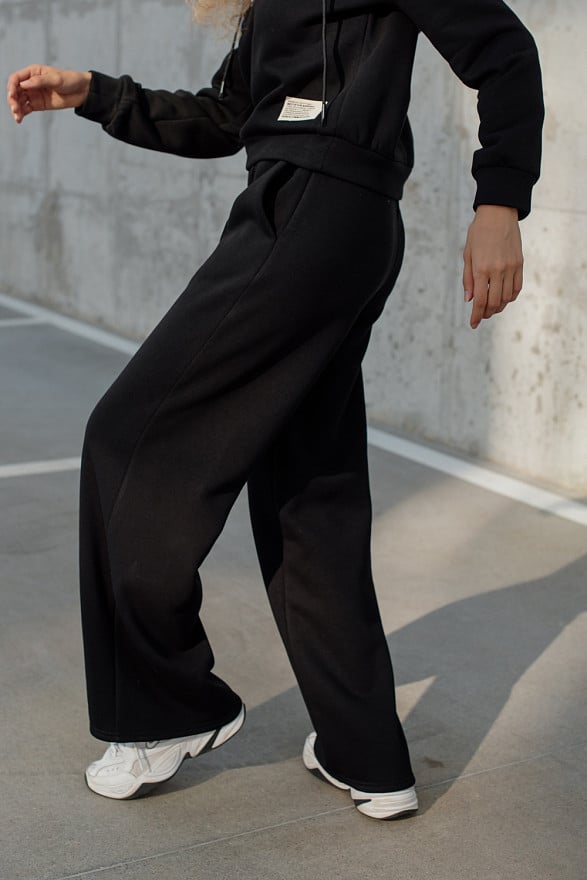 Warm black flared trousers with arrows