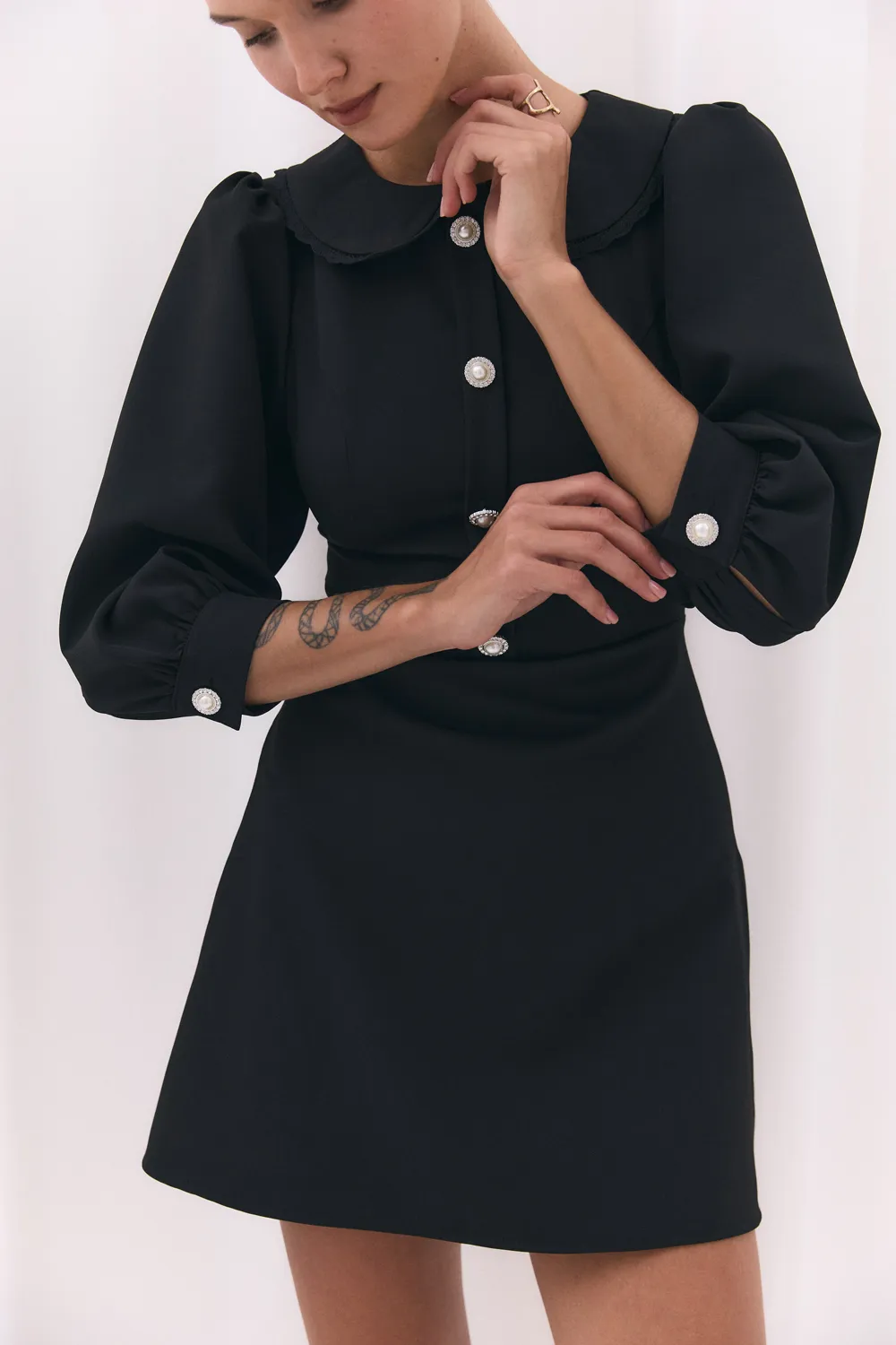 Black fitted dress with a-line skirt and lace collar